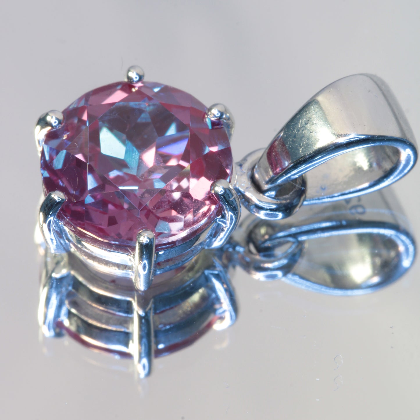Lab Alexandrite Pendant in sterling silver, 10mm round showing multicolors due to multiple lights.