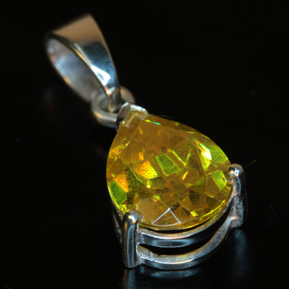 Faceted Orange Bismuth Germanate Pear-cut pendant in sterling silver on a black background