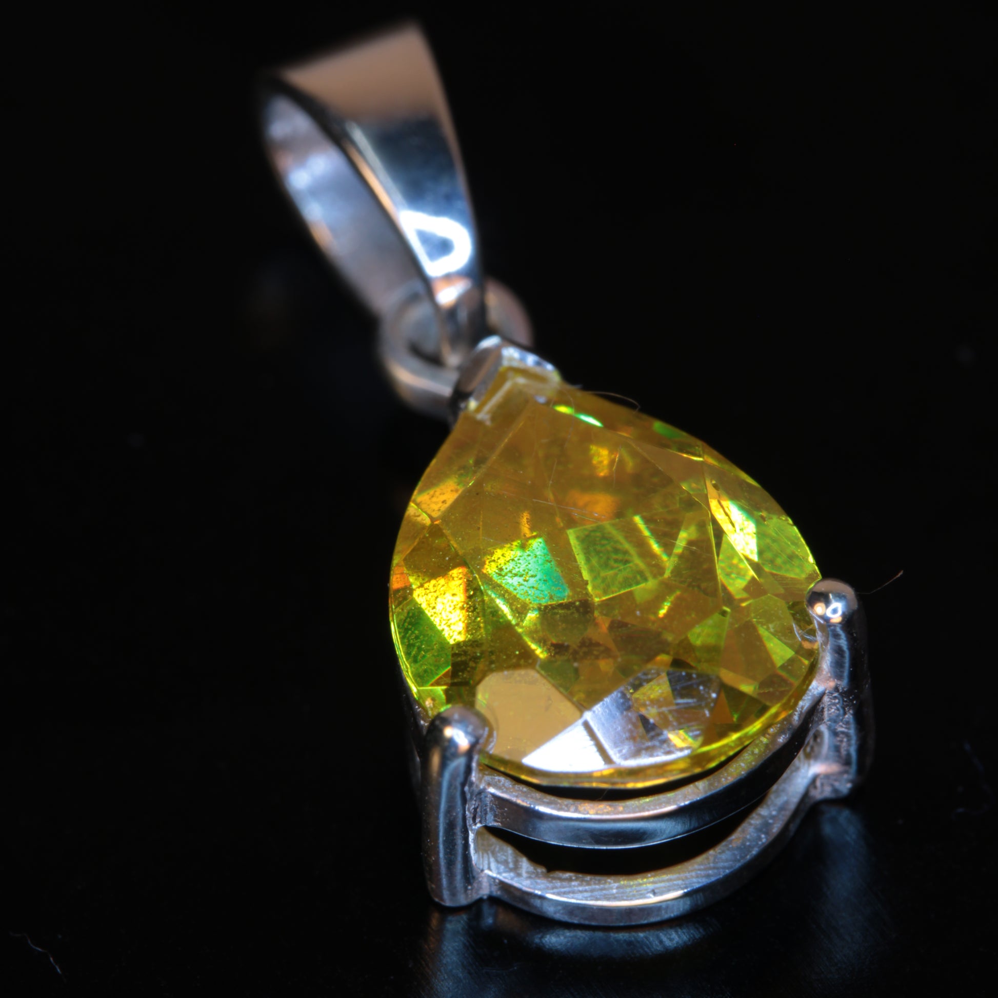 Faceted Orange BGO20 Pear-cut pendant in sterling silver on a black background
