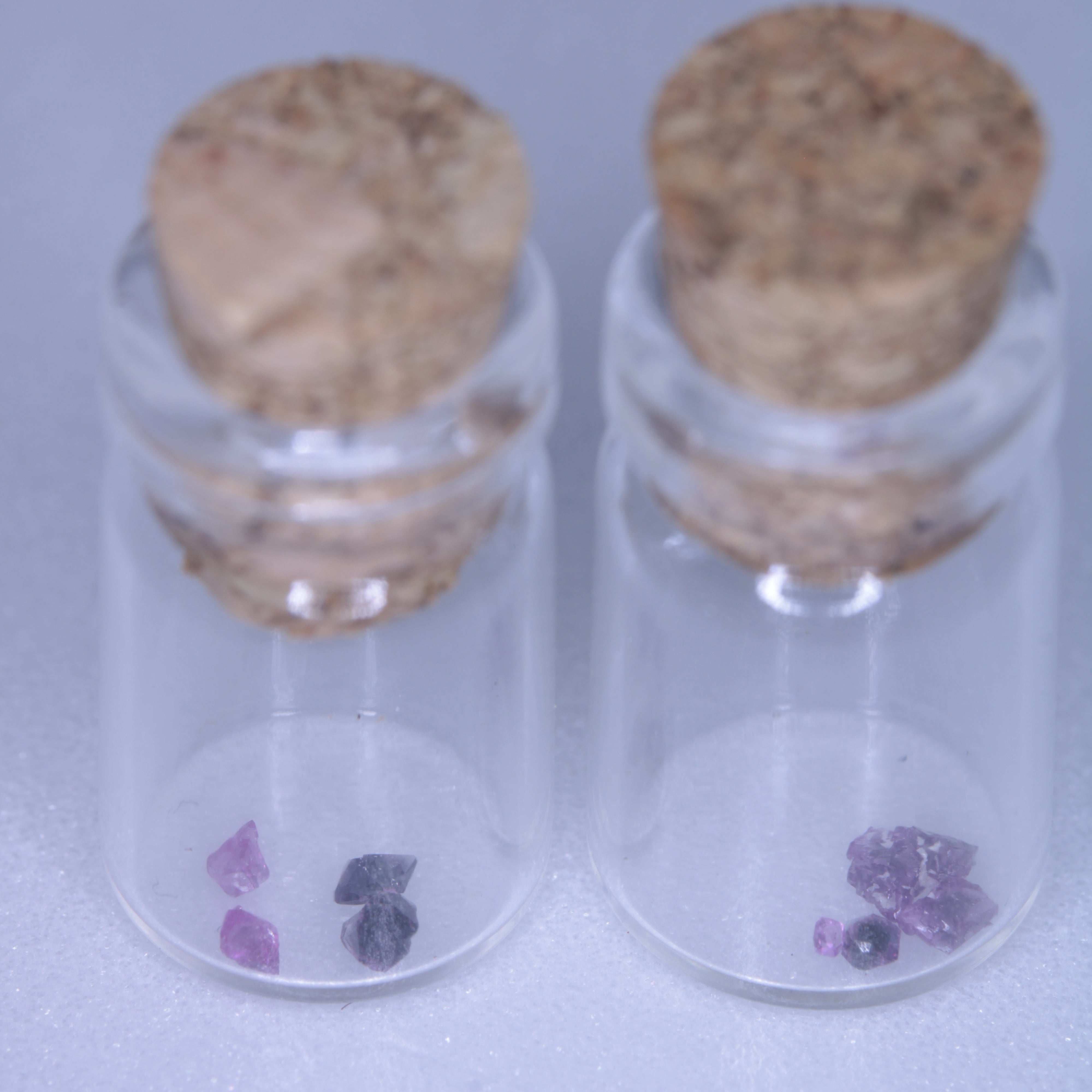 A glass vial containing flux grown rubies