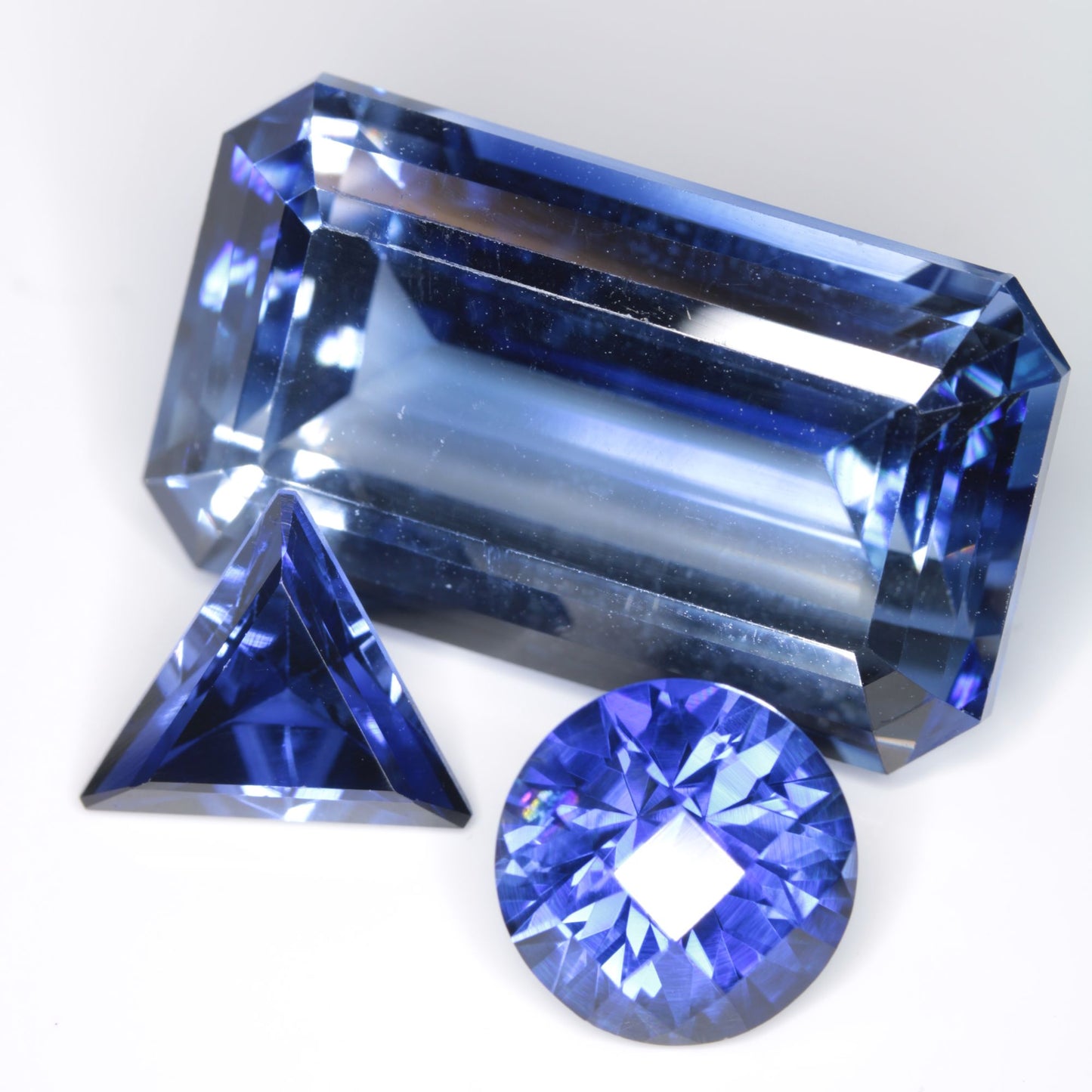 Three Blue Flame Fusion Sapphire Gems showing their different color intensities
