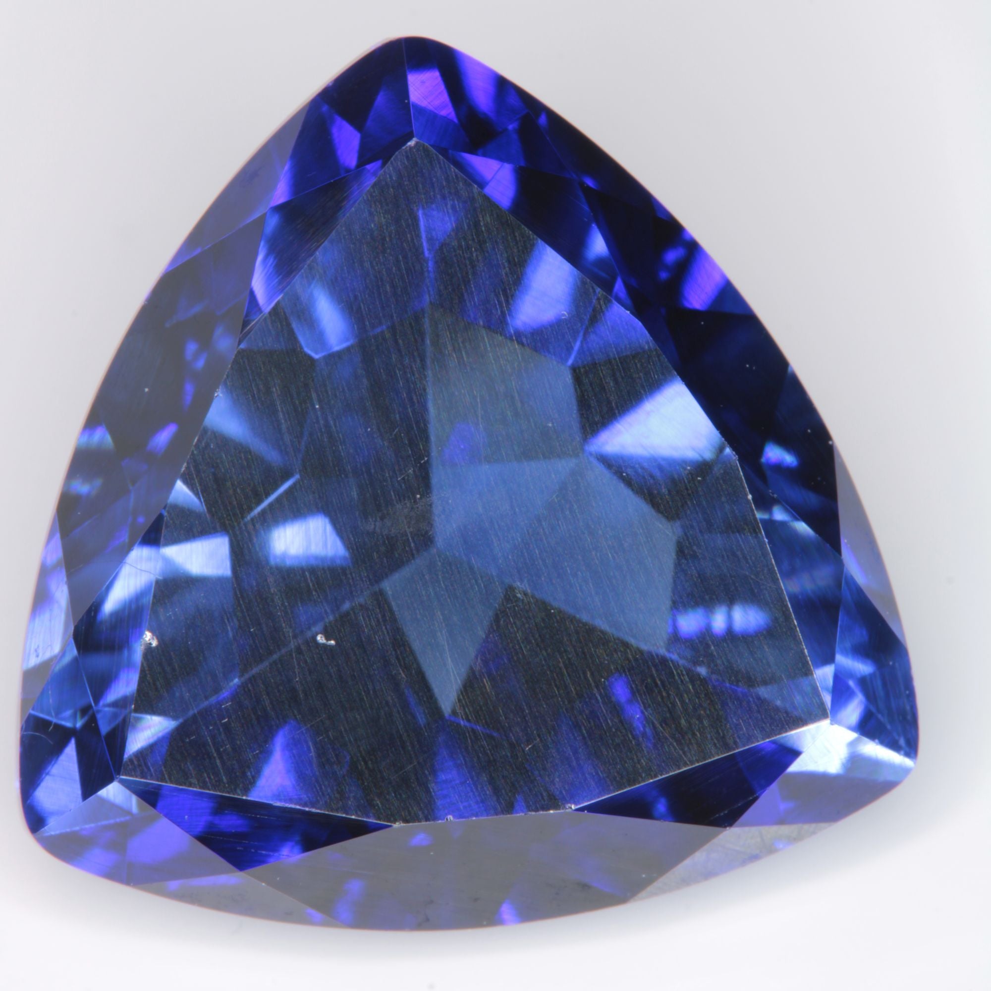 Faceted Flame Fusion Blue Sapphire Trillion (Face chip) Gemstone