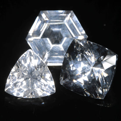 Three Faceted Gemstones cut from clear F-35 Fighter Jet Sapphire Under Normal Light