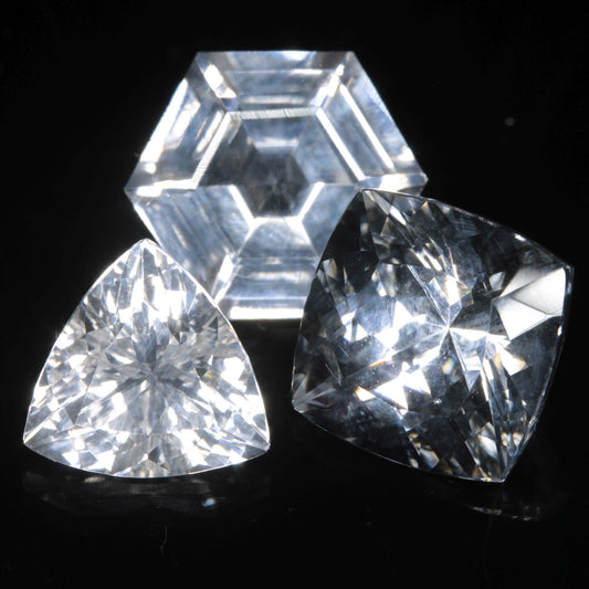 Three Faceted Gemstones cut from clear F-35 Fighter Jet Sapphire Under Normal Light