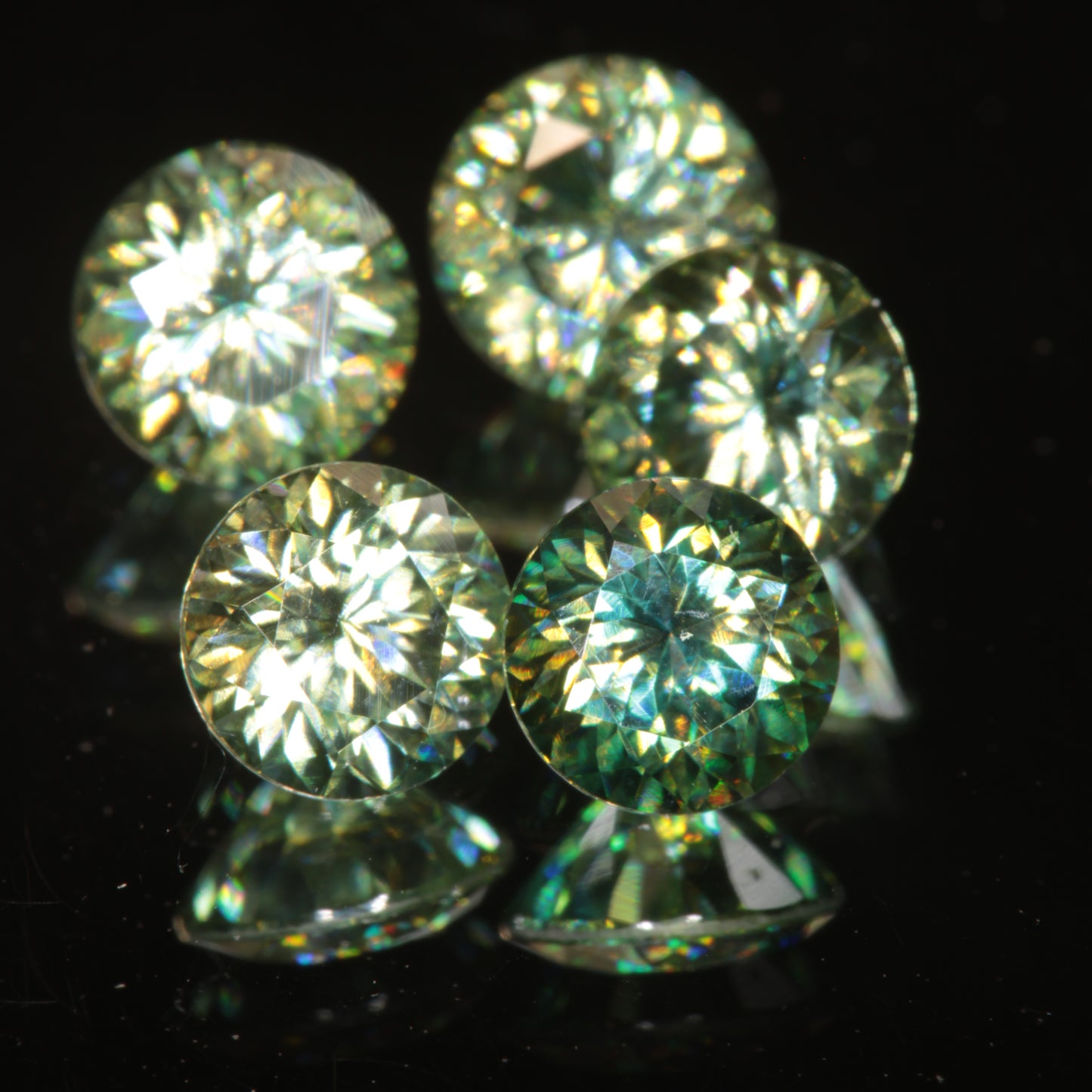 Round Dichroic Moissanite Gems, Showing Yellow and Blue Sparks from the stone’s dichroism