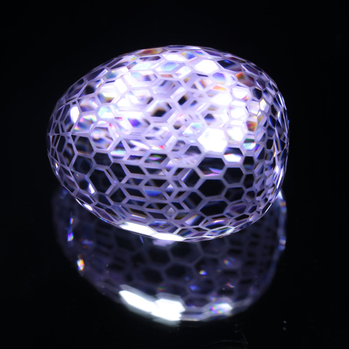 Faceted Nd:YAG Egg With Frosted Edges Gemstone on a black Background