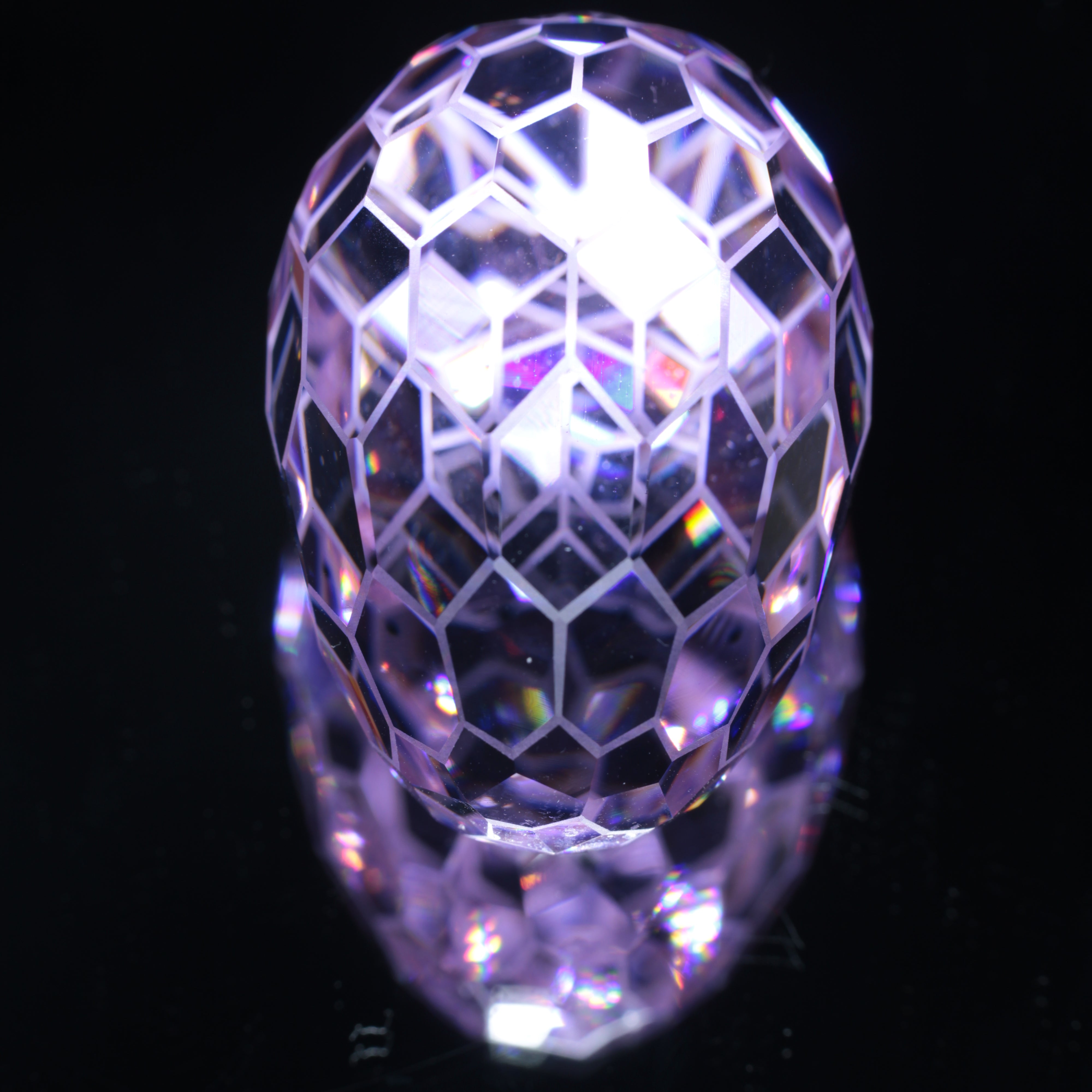 Faceted Nd:YAG Long Egg with Frosted Edges Gemstone on a black Background