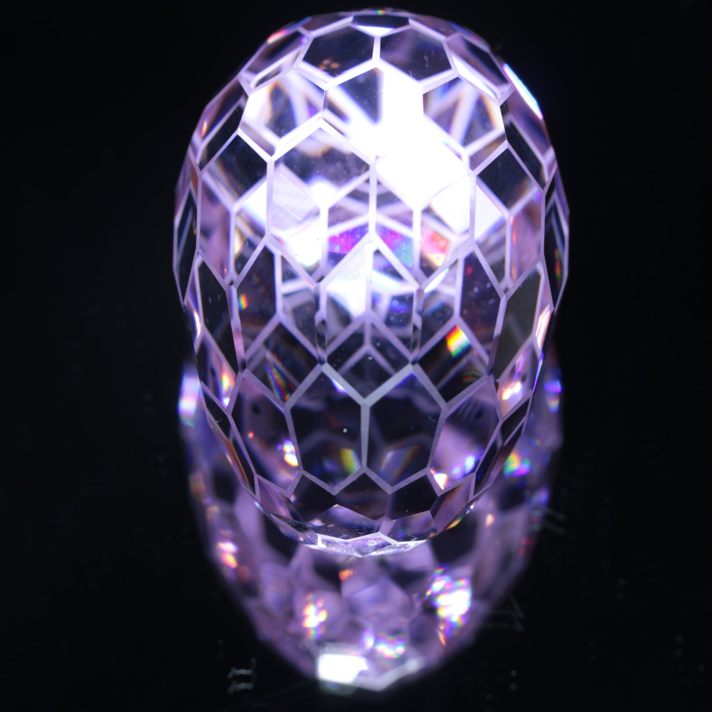 Faceted Nd:YAG Long Egg with Frosted Edges Gemstone on a black Background