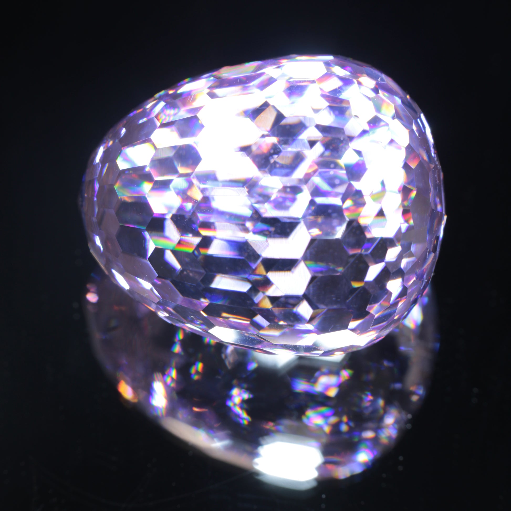 Faceted Nd:YAG Egg Gemstone on a black Background