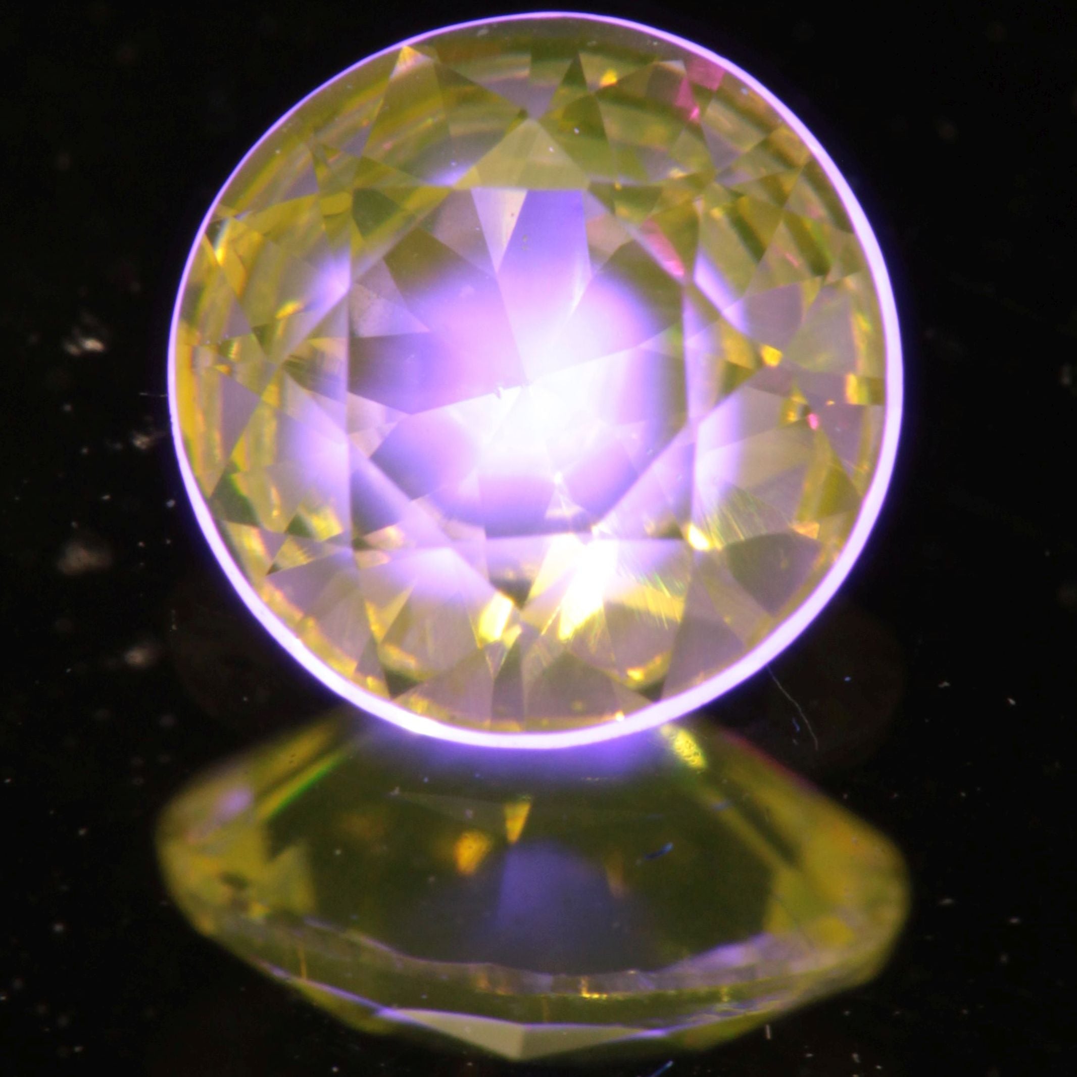 Faceted Green/Yellow Ce/Nd YAG Gem with a black “Bullseye” at the tip