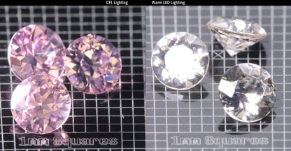 Faceted Er/Nd YAG displayed under two lights, CFL on the left making it pink, warm led on the right making it yellow, demonstrating the colorchange on a  Round gemstone