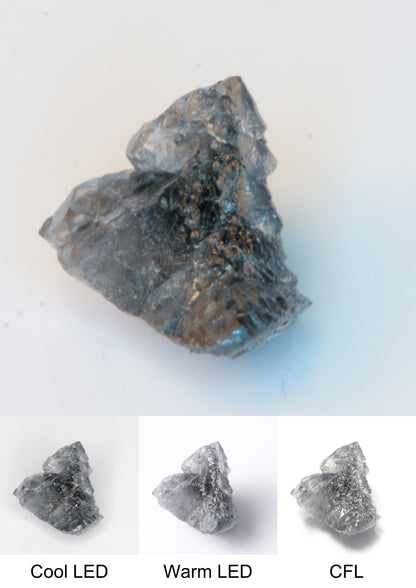 Synthetic Flux Playbutton Sapphire Cluster Gemstone Grown by Gems of Science on a white background showing color shift under different lighting
