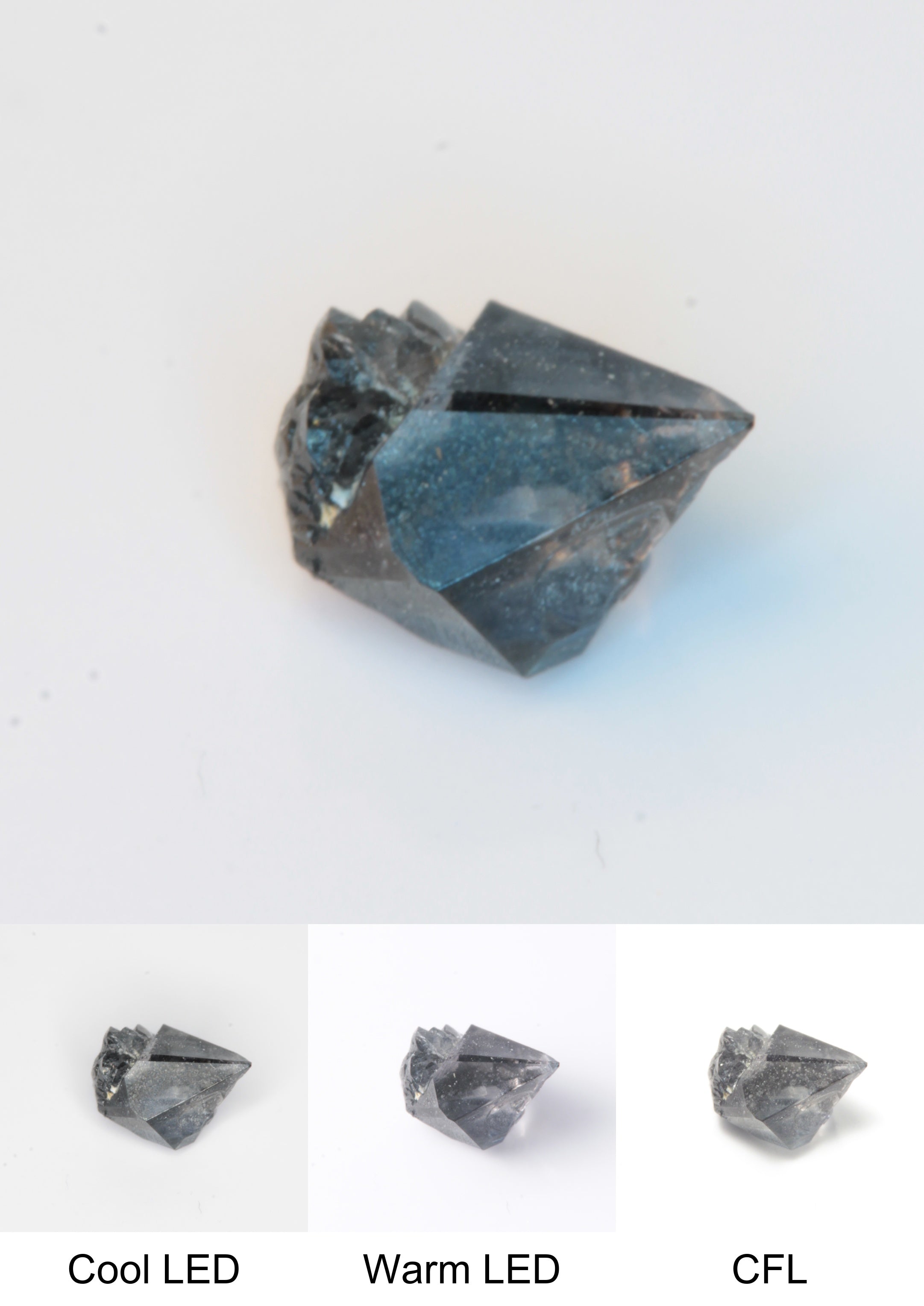 Synthetic Flux Playbutton Sapphire Gemstone Grown by Gems of Science on a white background showing color shift under different lighting