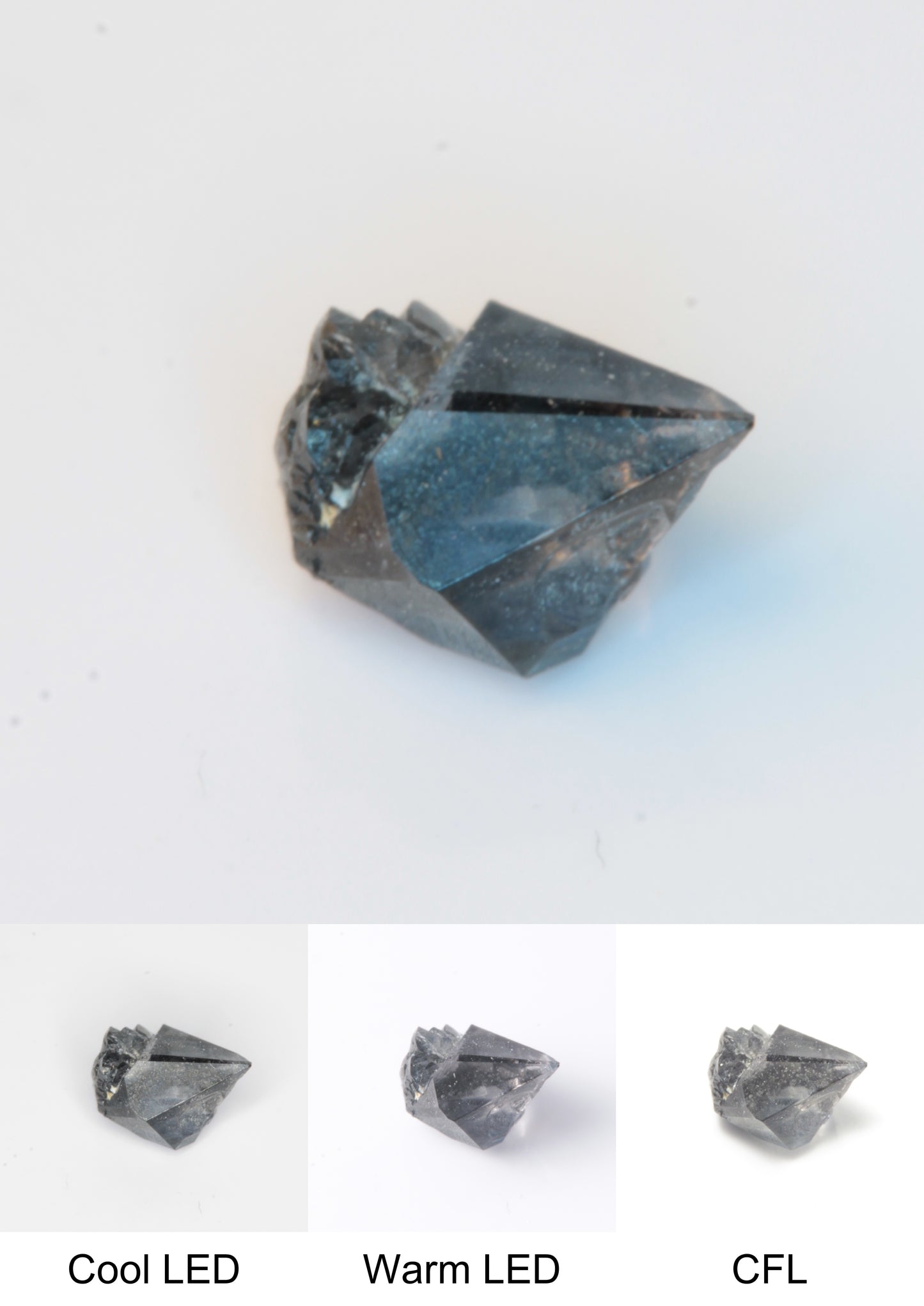 Synthetic Flux Playbutton Sapphire Gemstone Grown by Gems of Science on a white background showing color shift under different lighting