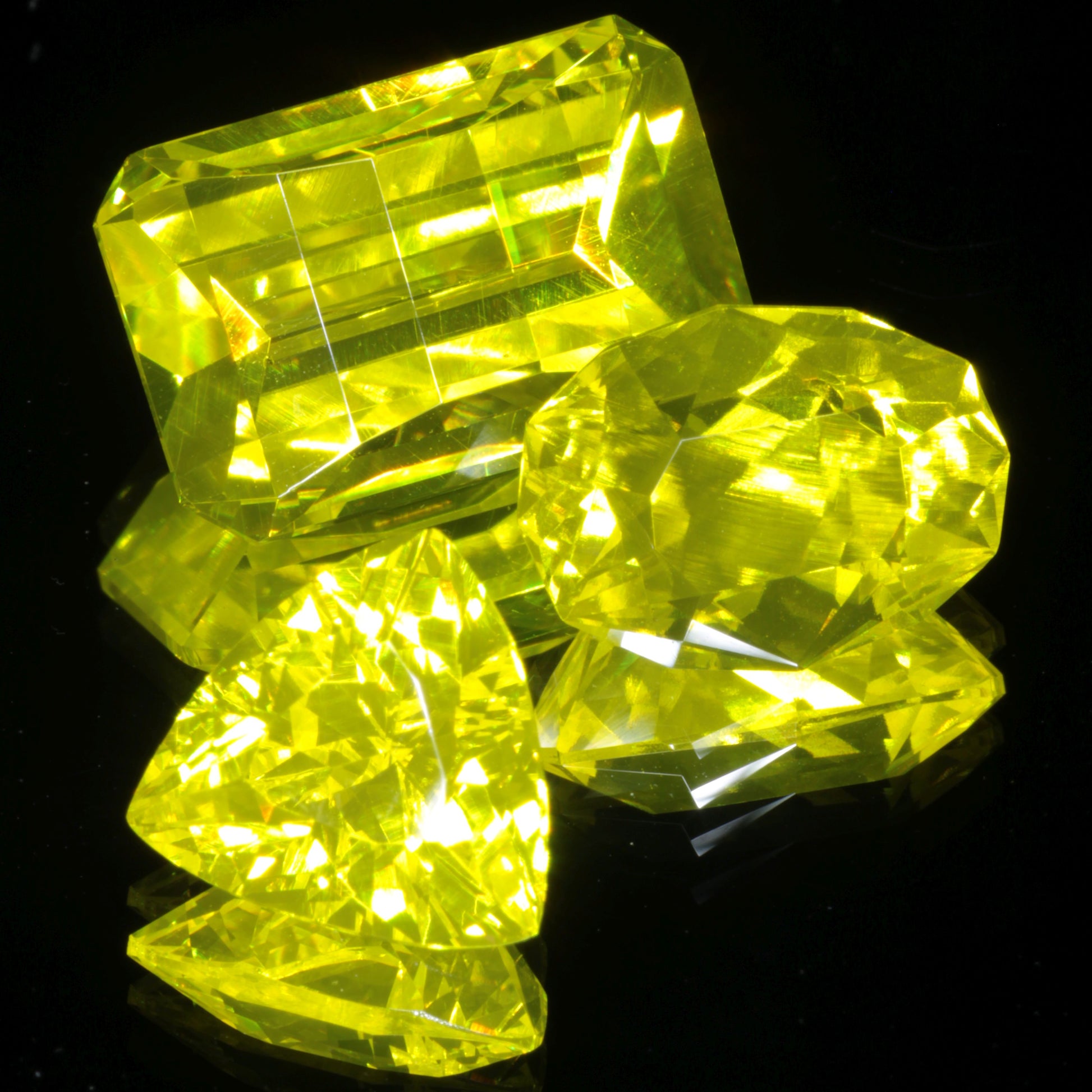 Three Bright Yellow Gems in Different Cuts (Faceted Gadolinium Aluminum Gallium Garnet (GAGG) Lumogarnet gemstones)