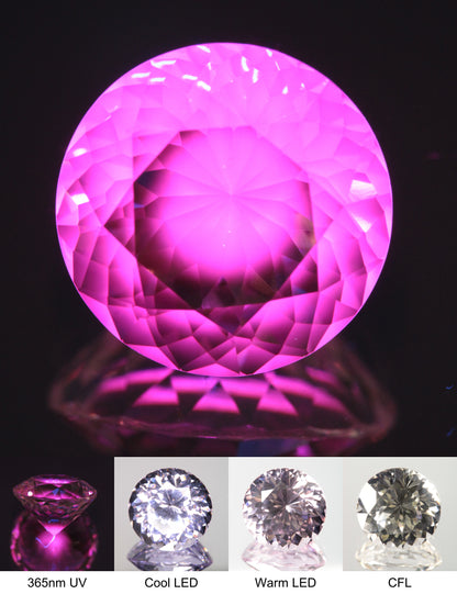 Faceted Violet Nd/Ce YAG Bullseye Round Gemstone with a spot of Pink Fluorescence at the Culet