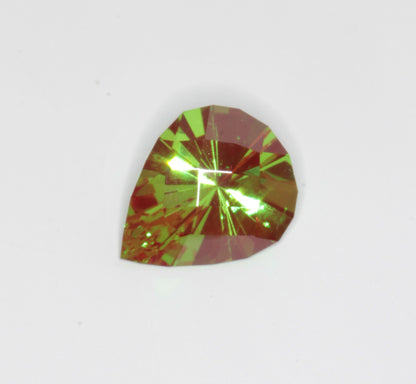 A pear cut green and red Christmas Garnet, Chromium YAG stone on a white background.