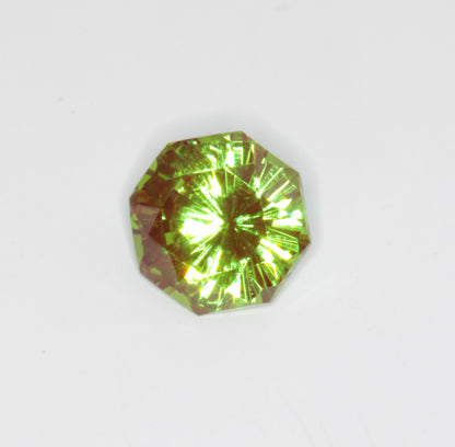 An Octagonal Christmas Garnet on a white background, showing the red and green cr:YAG colors