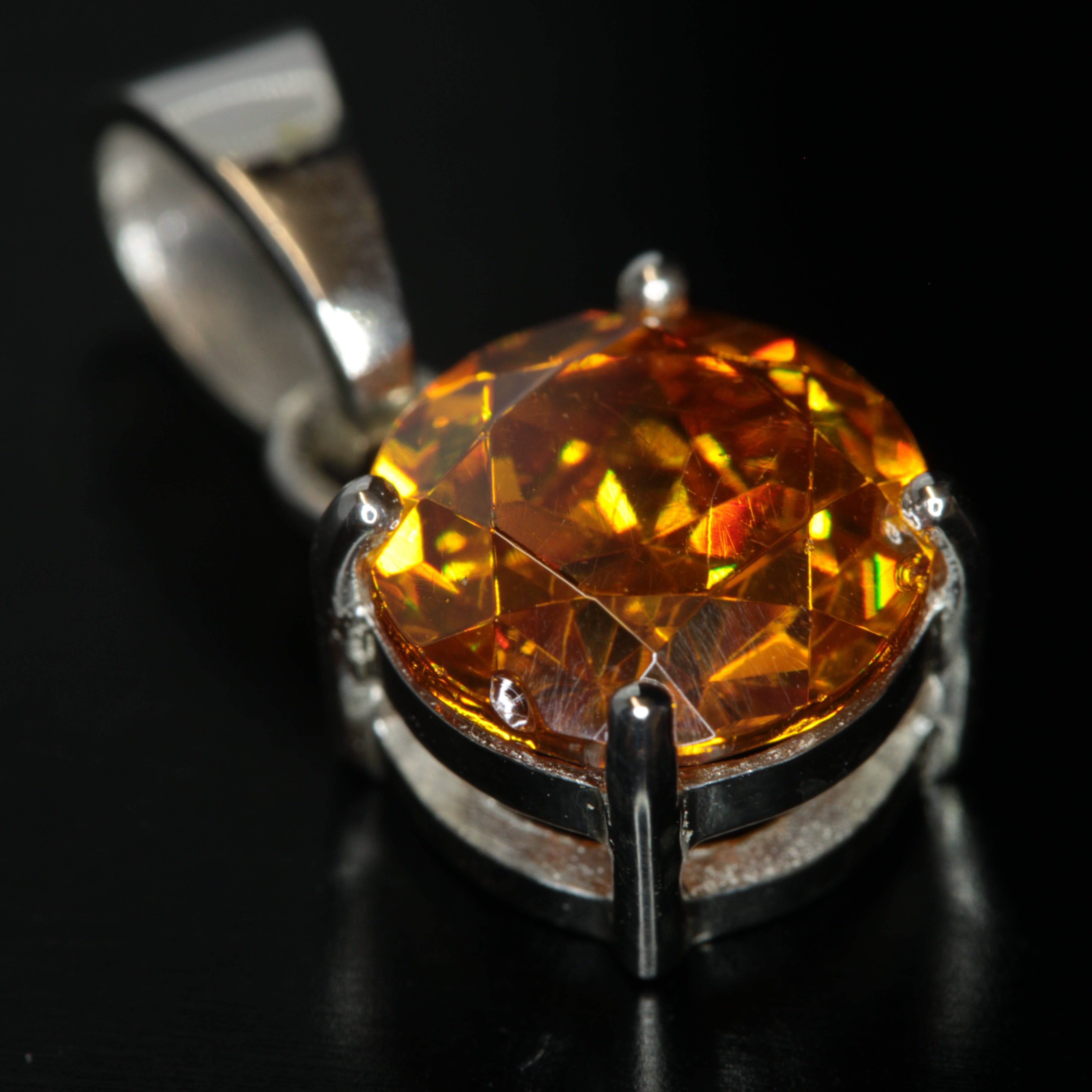 Round Cut Orange BGO20 pendant on a black background