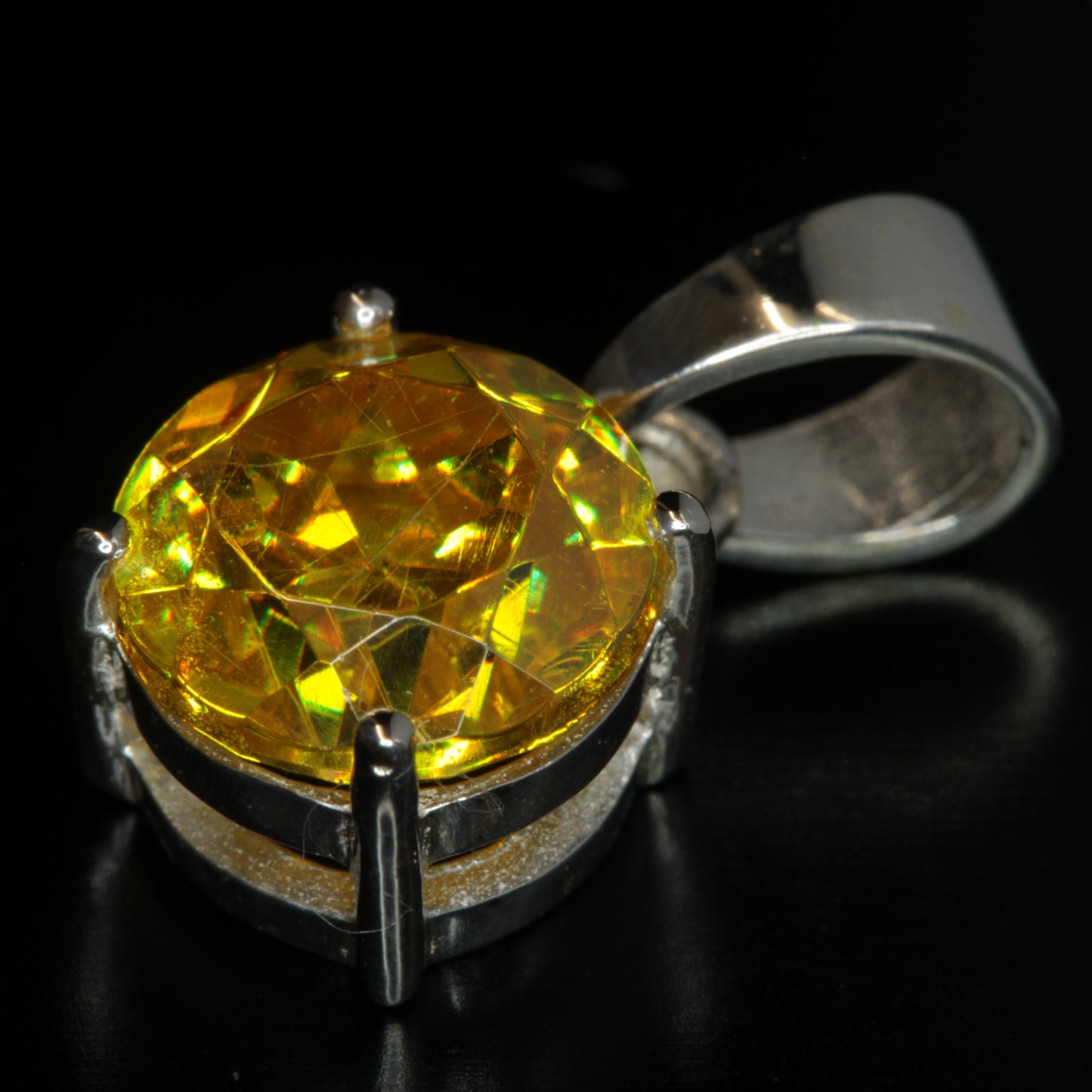 Yellow Faceted Bi12GeO20 Gemstone Pendant on a Black Background