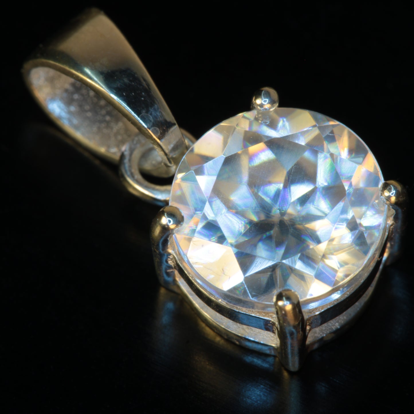 Faceted Lithium Niobate Pendant on a black background