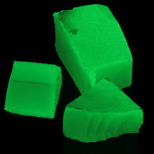 Three Pieces of Phosphorescent Lumenite Gem Rough, showing its glow-in-the-dark properties.