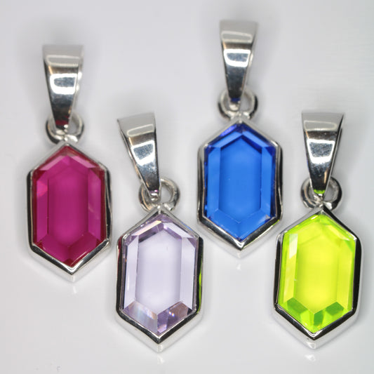 Four Retrohex pendants against a white background, made out of purple, red, blue, and green synthetic gems