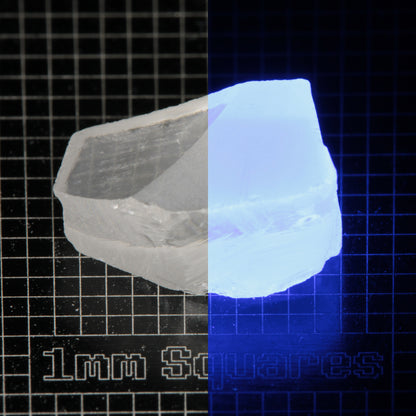 Block of LSO Gem Rough on a dark background, split between normal light (left) and UV (right) to show blue fluorescent glow.