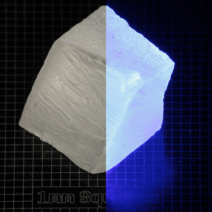 Several pieces of of LSO Gem Rough on a dark background, split between normal light (left) and UV (right) to show blue fluorescent glow.