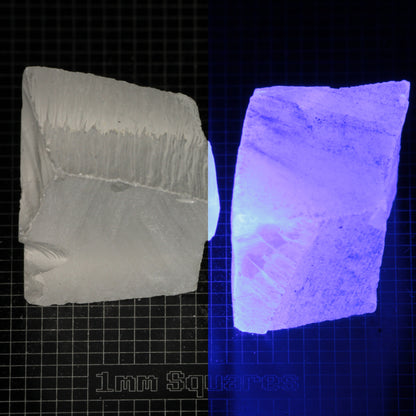 Several pieces of of LSO Gem Rough on a dark background, split between normal light (left) and UV (right) to show blue fluorescent glow.