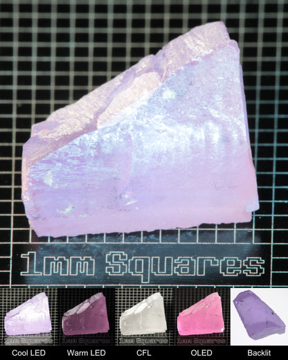 Nd:GGG Edge Gem Rough Under Multiple Lights Showing the Color Change