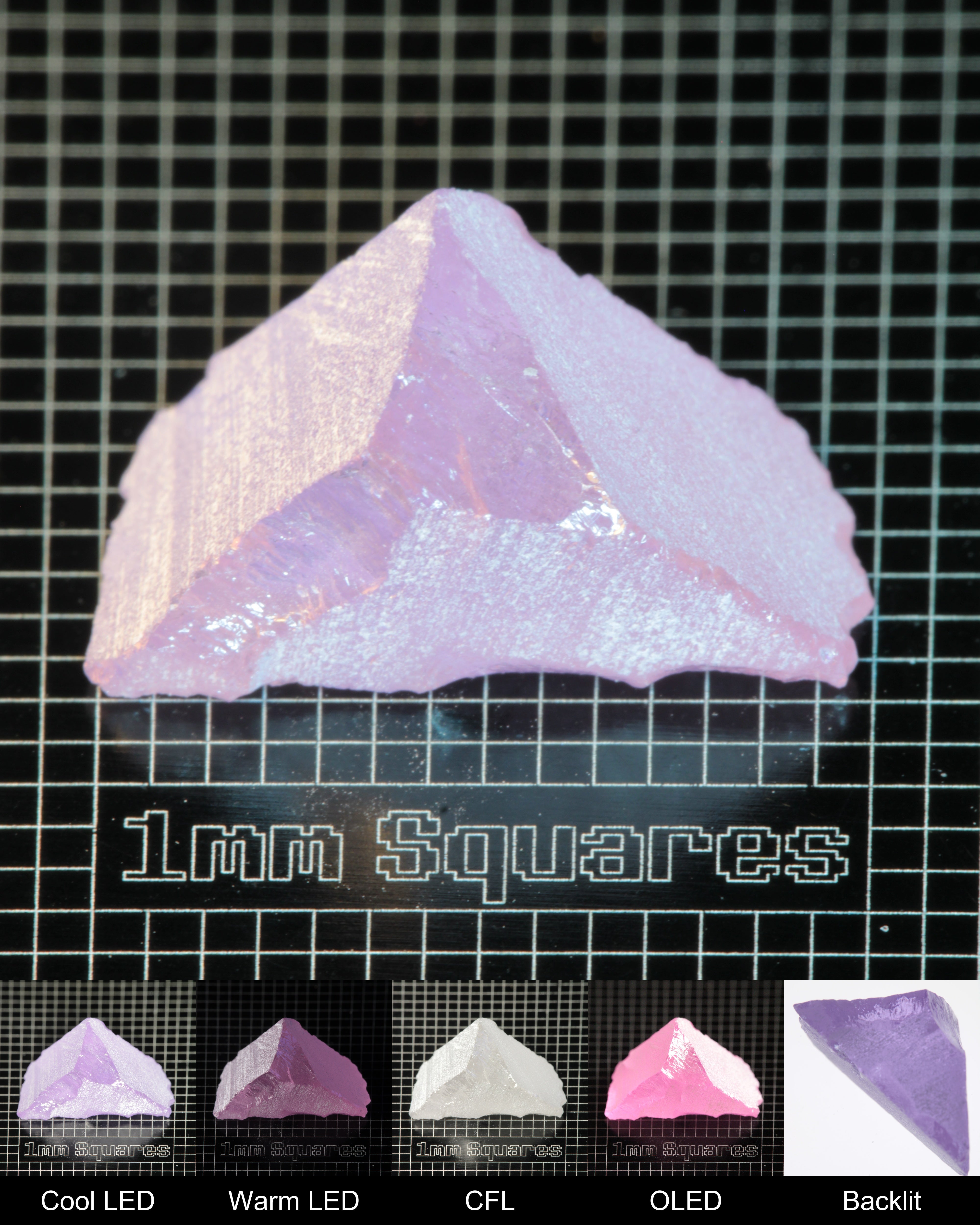 Nd:GGG Triangular Wedge Gem Rough Under Multiple Lights Showing the Color Change