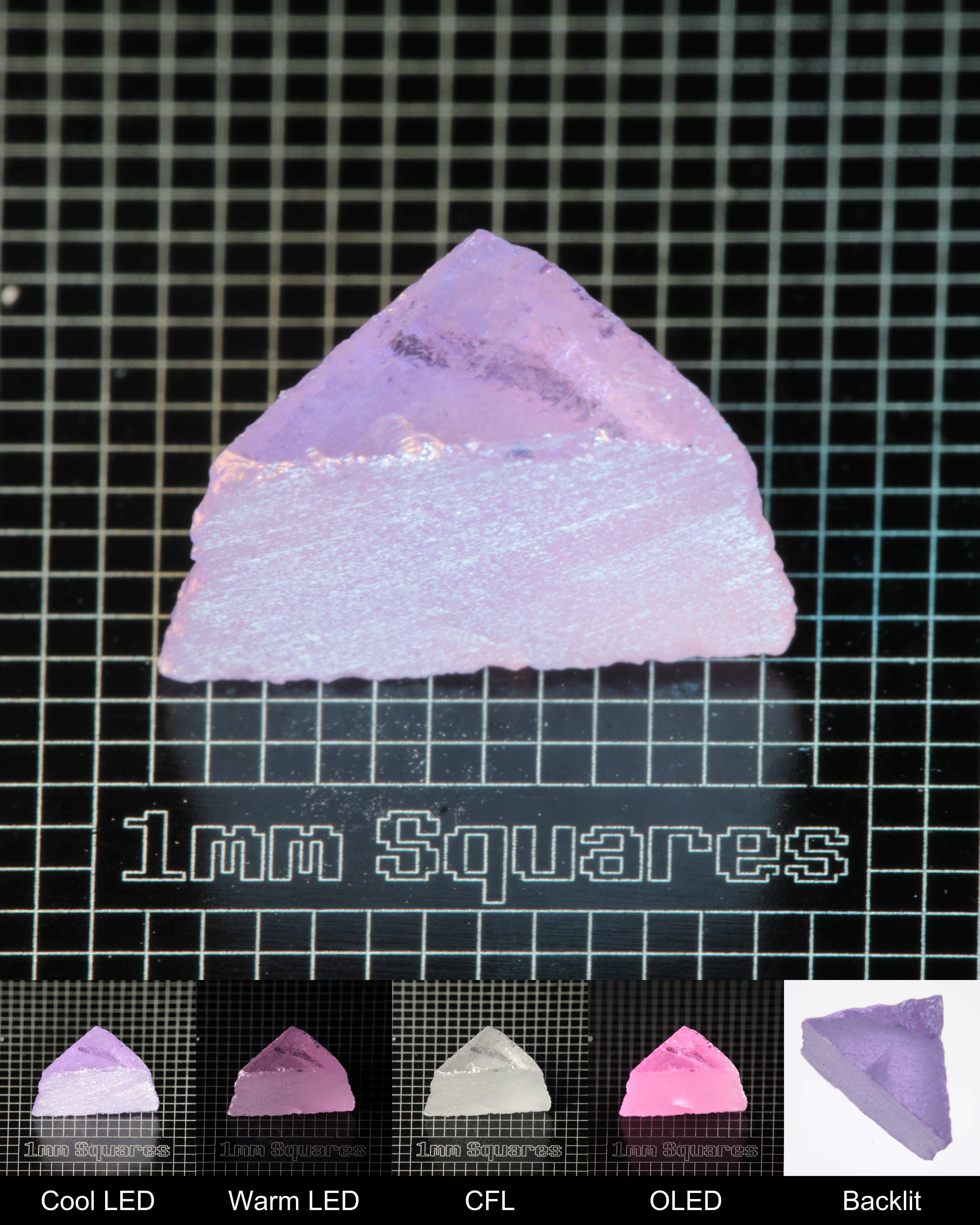 Nd:GGG Triangular Wedge Gem Rough Under Multiple Lights Showing the Color Change