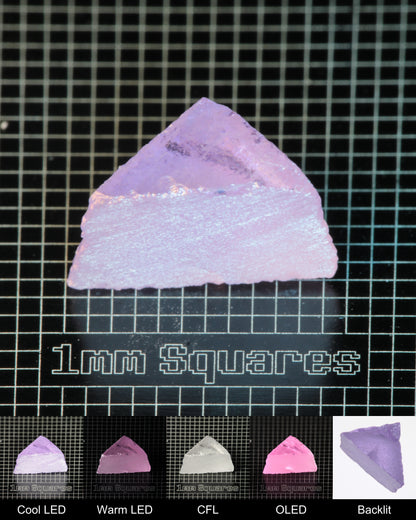 Nd:GGG Triangular Wedge Gem Rough Under Multiple Lights Showing the Color Change