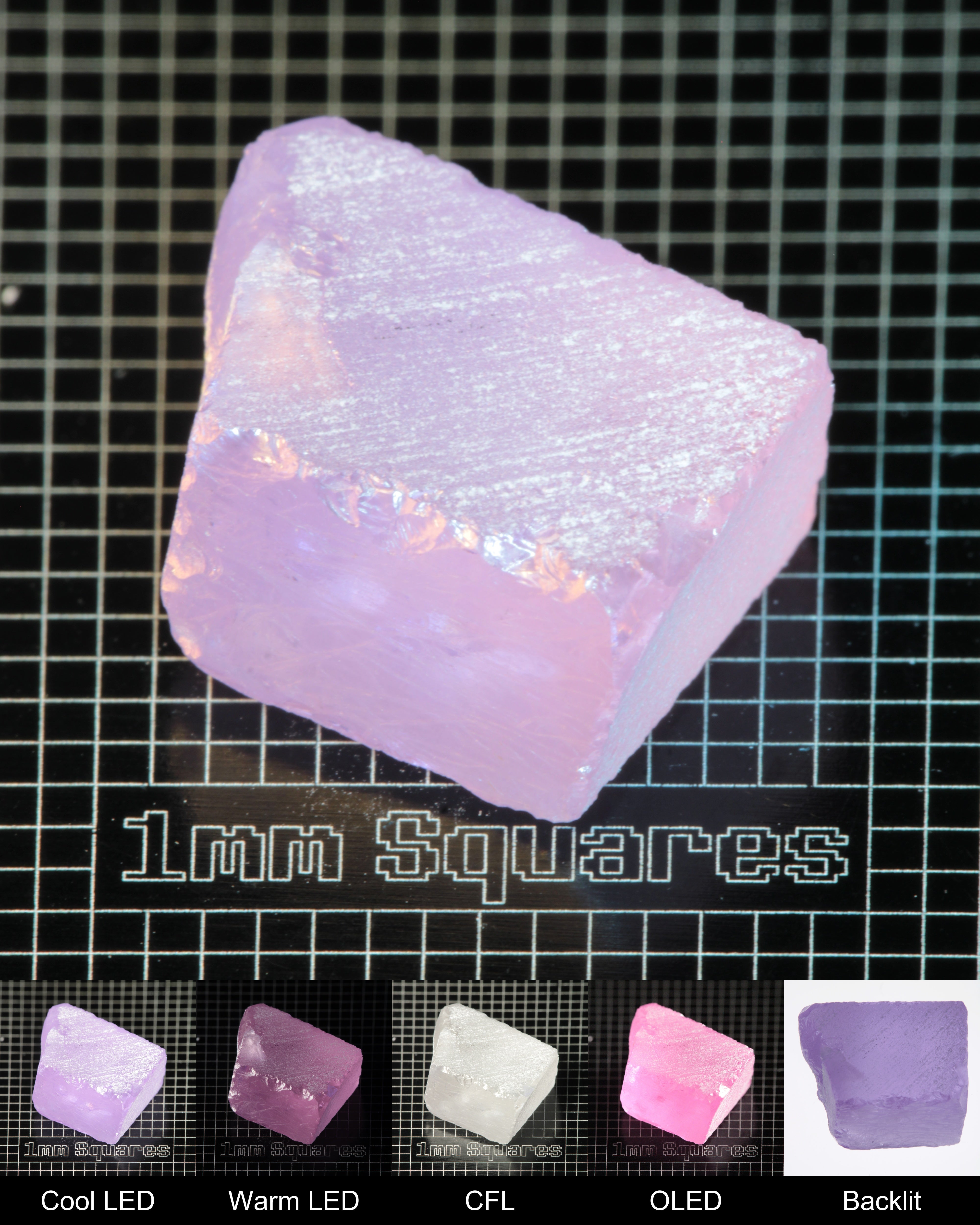 Nd:GGG Block Gem Rough Under Multiple Lights Showing the Color Change