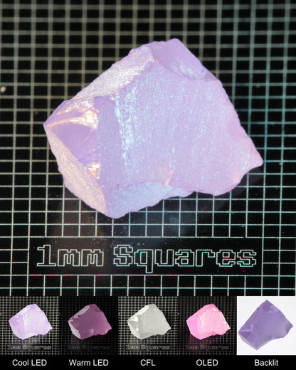 Nd:GGG Wedge Gem Rough Under Multiple Lights Showing the Color Change