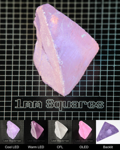 Nd:GGG Chunk Gem Rough Under Multiple Lights Showing the Color Change