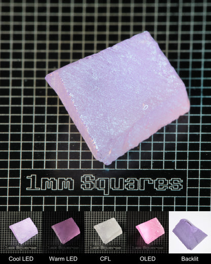 Nd:GGG Triangular Wedge Gem Rough Under Multiple Lights Showing the Color Change