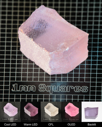 Nd:GGG Block Gem Rough Under Multiple Lights Showing the Color Change