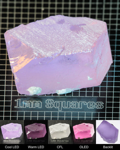 Nd:GGG Chunk Gem Rough Under Multiple Lights Showing the Color Change