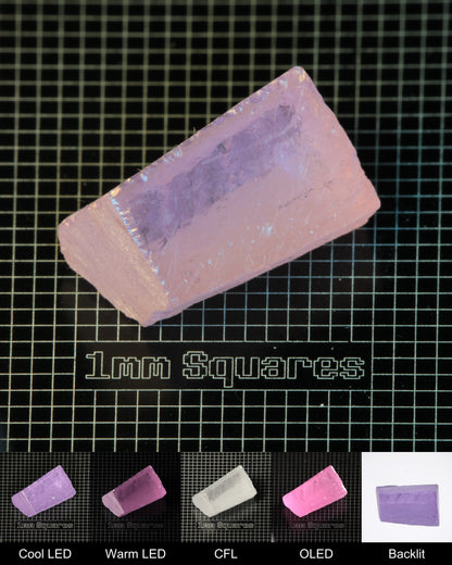 Nd:GGG Block Gem Rough Under Multiple Lights Showing the Color Change