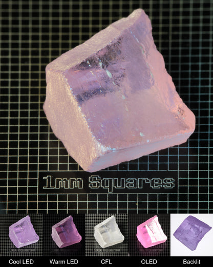 Nd:GGG Block Gem Rough Under Multiple Lights Showing the Color Change