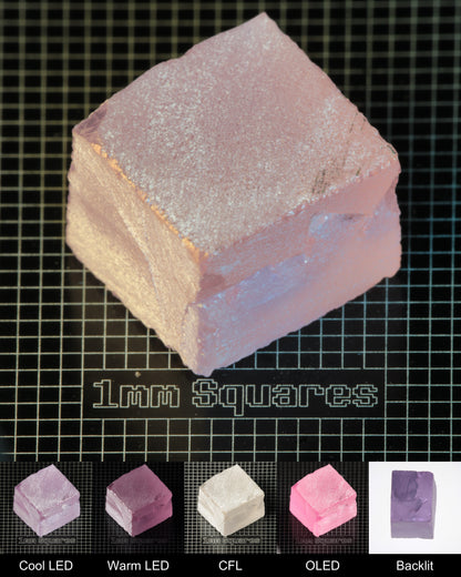 Nd:GGG Cracked Block Gem Rough Under Multiple Lights Showing the Color Change