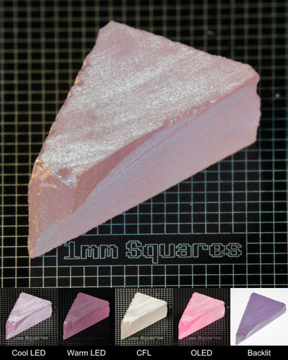 Nd:GGG Triangular Block Gem Rough Under Multiple Lights Showing the Color Change