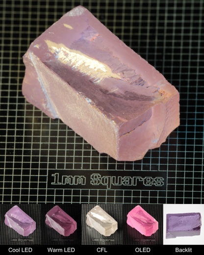 Nd:GGG Block Gem Rough Under Multiple Lights Showing the Color Change
