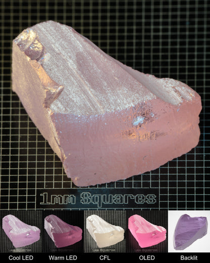 Nd:GGG Triangular Block Gem Rough Under Multiple Lights Showing the Color Change
