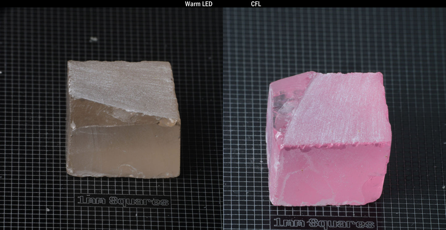 Individual piece of Nd/Er YAG, showing color change with the yellow color under warm LEDs on the left, and the pink color under CFL on the right.