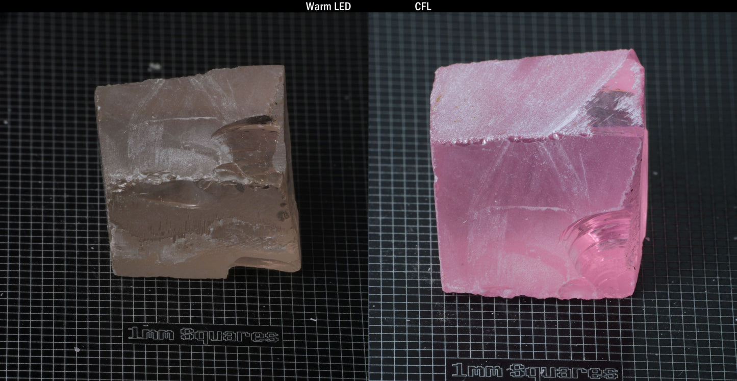 Individual piece of Nd/Er YAG, showing color change with the yellow color under warm LEDs on the left, and the pink color under CFL on the right.