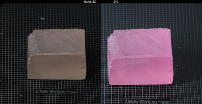Individual piece of Nd/Er YAG, showing color change with the yellow color under warm LEDs on the left, and the pink color under CFL on the right.