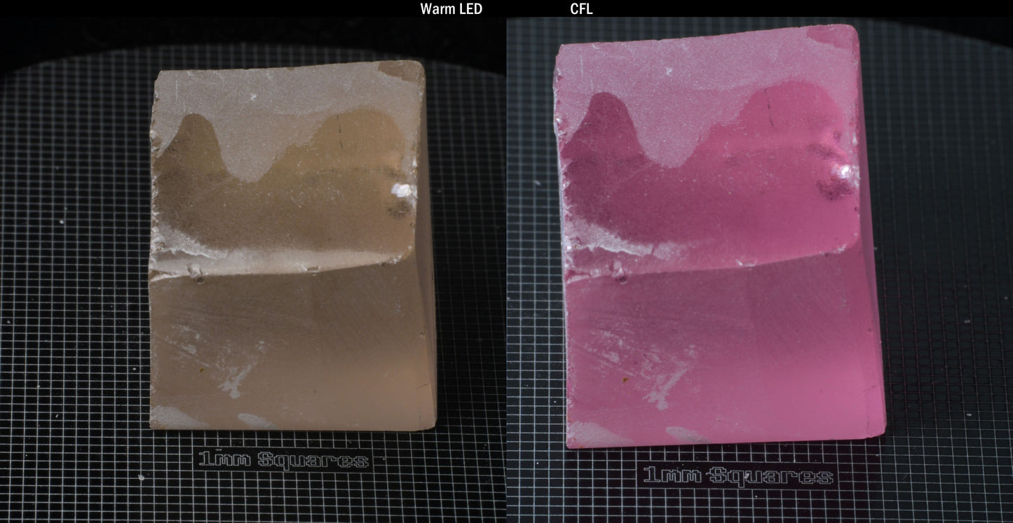 Individual piece of Nd/Er YAG, showing color change with the yellow color under warm LEDs on the left, and the pink color under CFL on the right.